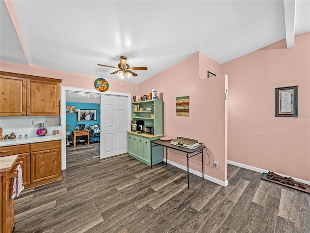 kitchen with ceiling fan, dark wood-type flooring, vaulted ceiling, and tasteful backsplash