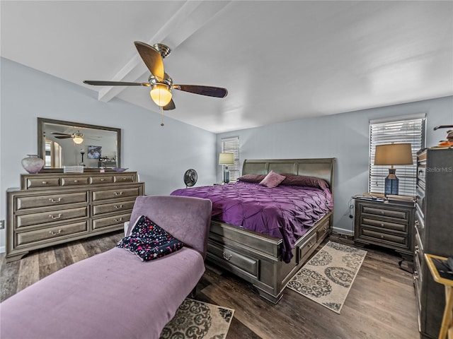 bedroom with ceiling fan, dark wood-type flooring, and beamed ceiling