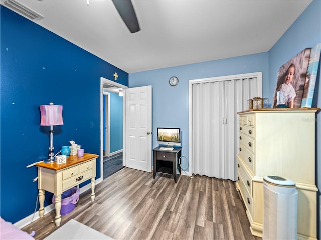 interior space with hardwood / wood-style floors, ceiling fan, and a closet