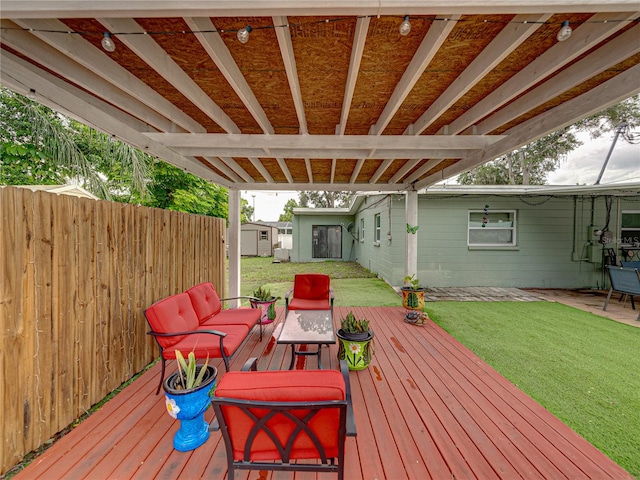 wooden terrace with a shed and a lawn