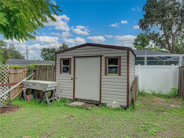 view of outdoor structure featuring a lawn