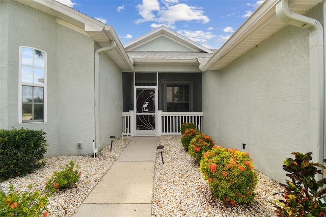 entrance to property with crawl space and stucco siding