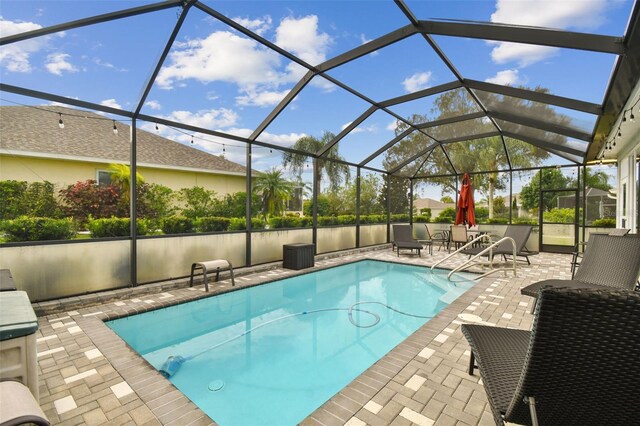 view of pool with a patio and a lanai