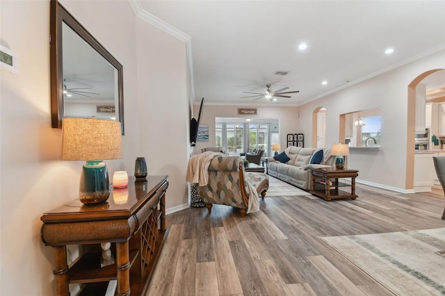 living room with ceiling fan, french doors, hardwood / wood-style floors, and ornamental molding