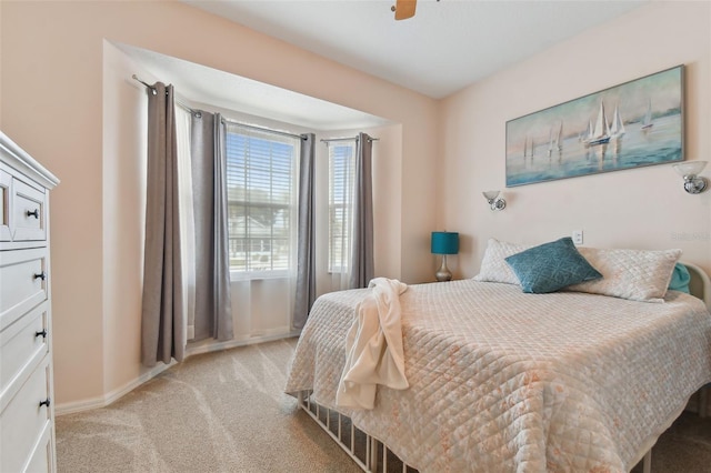 bedroom with baseboards, light carpet, and ceiling fan