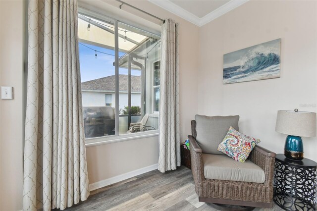 sitting room featuring crown molding and hardwood / wood-style flooring