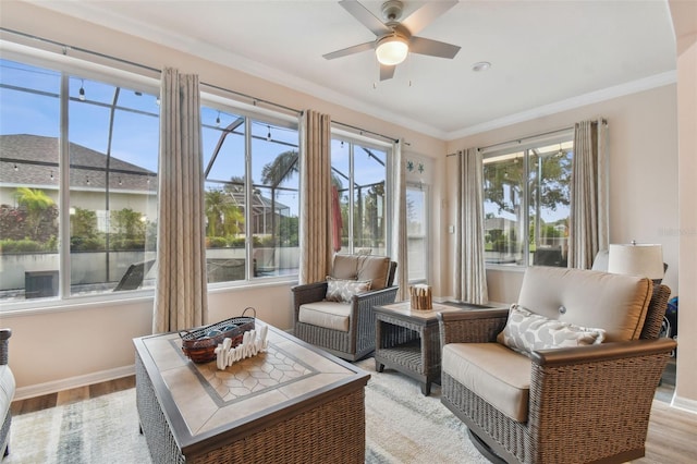 sunroom / solarium featuring ceiling fan