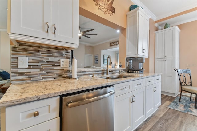 kitchen with white cabinetry, stainless steel dishwasher, ornamental molding, light stone countertops, and ceiling fan