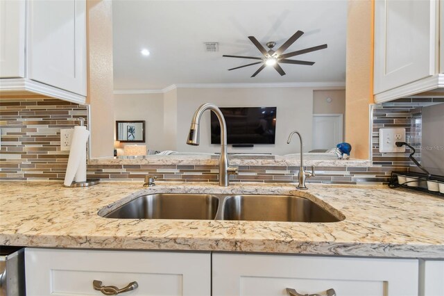 kitchen with sink, ceiling fan, decorative backsplash, and white cabinets