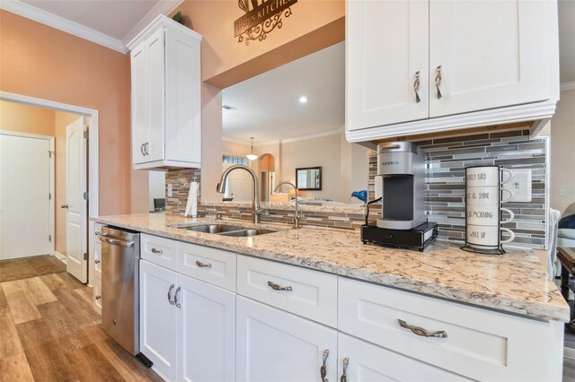 kitchen featuring sink, crown molding, decorative backsplash, and light wood-type flooring