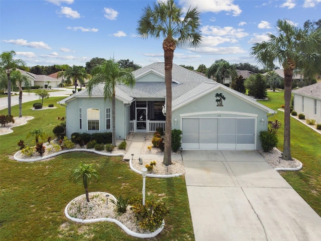 ranch-style house featuring concrete driveway, a garage, a front yard, and stucco siding