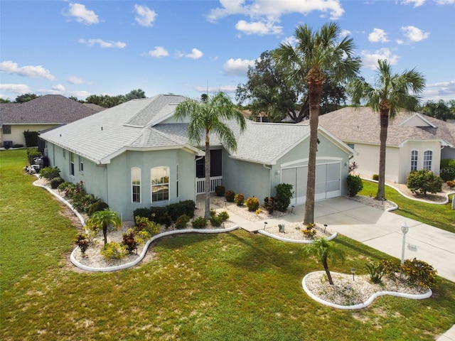 view of front facade featuring stucco siding, a front lawn, driveway, roof with shingles, and a garage