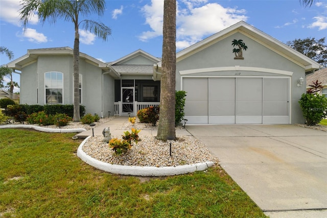 ranch-style house with stucco siding, a front yard, concrete driveway, and an attached garage