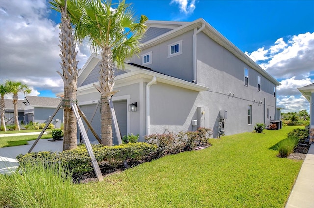 view of property exterior with a lawn, driveway, and stucco siding