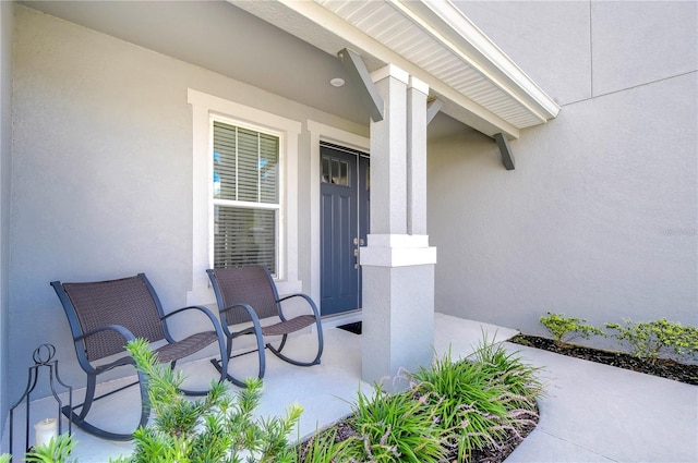 doorway to property featuring stucco siding