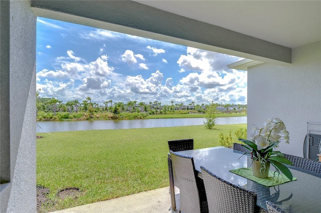 exterior space with outdoor dining space and a water view