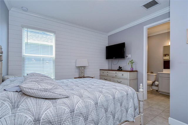 bedroom featuring light tile patterned floors, ornamental molding, ensuite bath, and visible vents