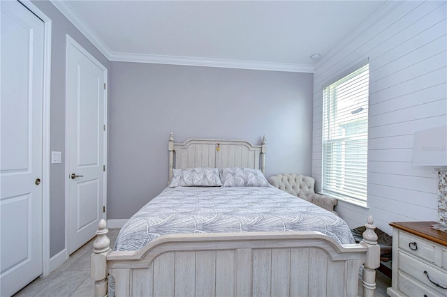 bedroom featuring light tile patterned flooring and crown molding