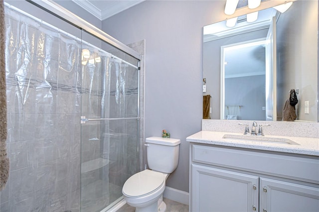 bathroom with toilet, vanity, baseboards, ornamental molding, and a stall shower