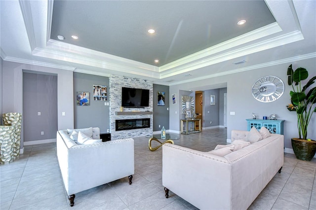 living area with a tray ceiling, a fireplace, baseboards, and light tile patterned floors