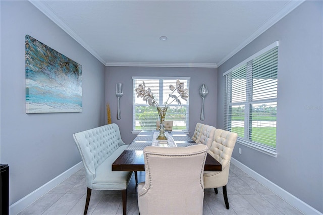 dining area with baseboards, ornamental molding, and light tile patterned flooring