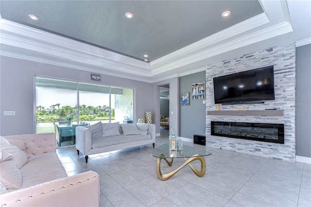 tiled living room featuring a large fireplace, baseboards, a raised ceiling, a textured ceiling, and crown molding