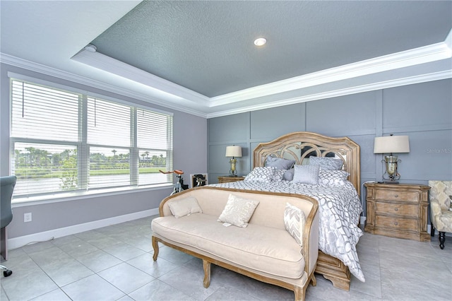 bedroom with a textured ceiling, light tile patterned floors, baseboards, ornamental molding, and a tray ceiling