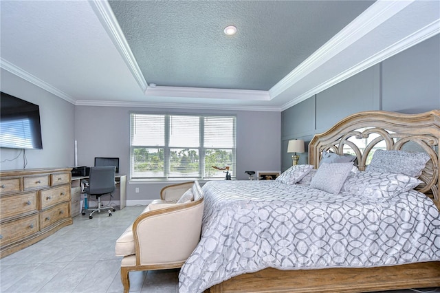 bedroom with light tile patterned floors, a textured ceiling, baseboards, a tray ceiling, and crown molding