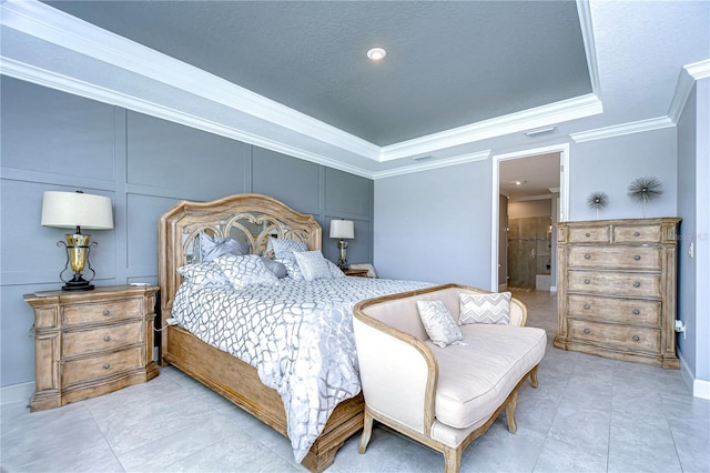 bedroom with ornamental molding, a raised ceiling, visible vents, and a decorative wall