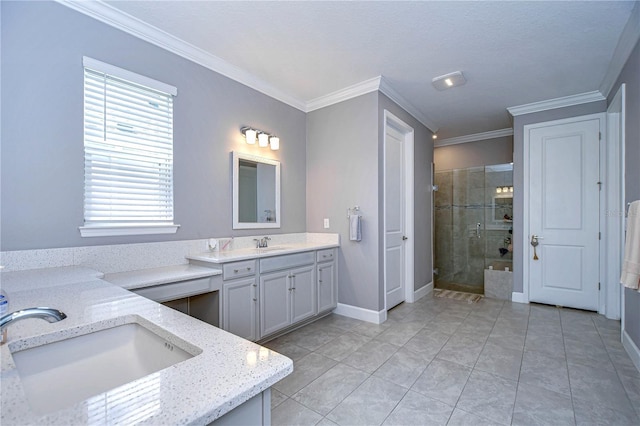 bathroom with two vanities, ornamental molding, a stall shower, a sink, and baseboards