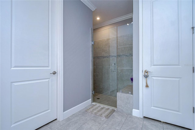 full bathroom with a stall shower, tile patterned flooring, baseboards, and crown molding