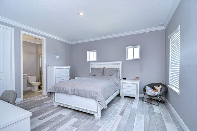 bedroom featuring baseboards, light wood finished floors, connected bathroom, and crown molding