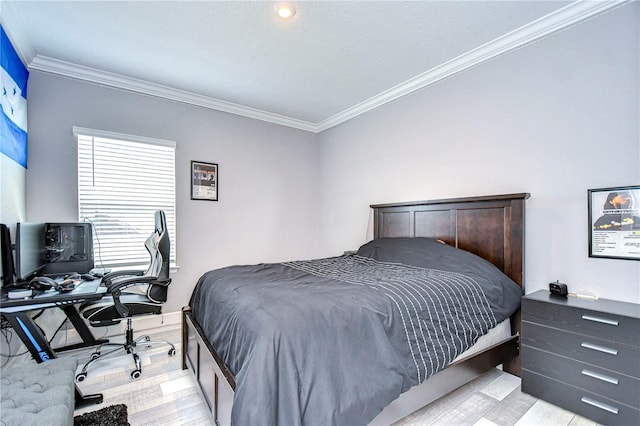 bedroom with ornamental molding and light wood finished floors