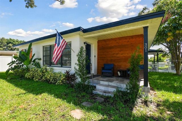 rear view of property with a lawn