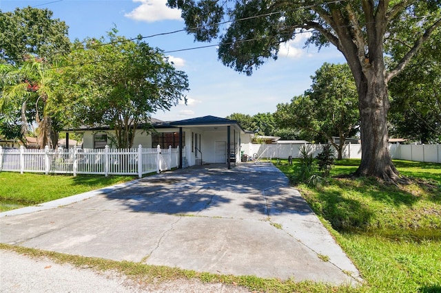 view of front facade featuring a front lawn and a carport