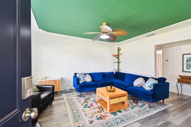 living room with ceiling fan and hardwood / wood-style floors