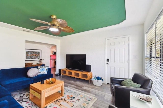 living room with hardwood / wood-style flooring and ceiling fan