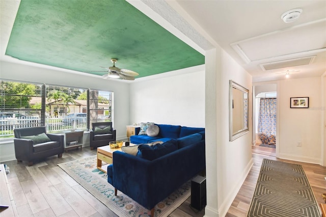 living room with ceiling fan and hardwood / wood-style flooring