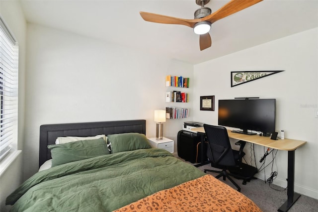 bedroom featuring ceiling fan and carpet