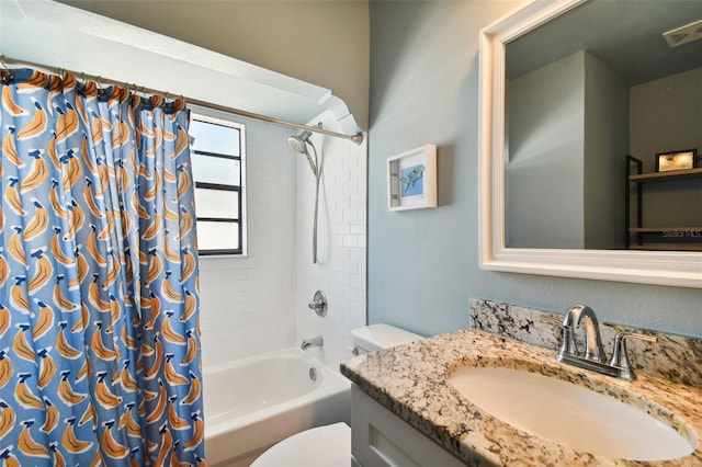 full bathroom with shower / bath combination with curtain, toilet, and vanity