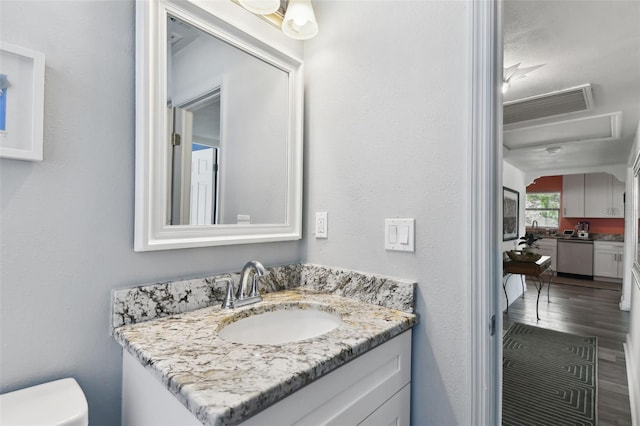 bathroom with hardwood / wood-style floors, toilet, and vanity