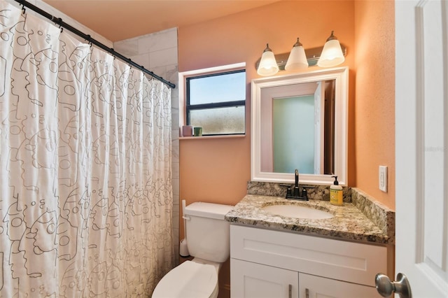 bathroom featuring vanity, toilet, and a shower with curtain