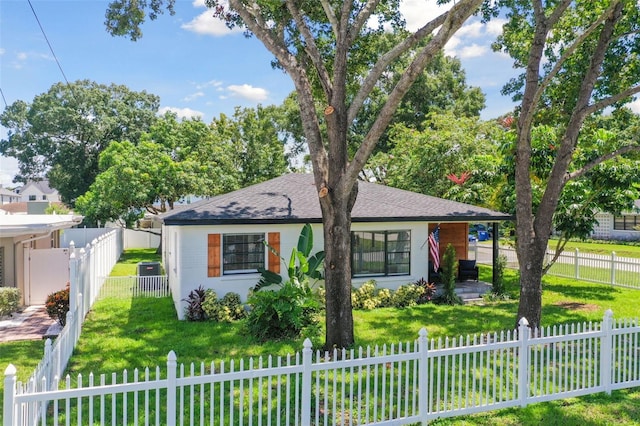 bungalow-style house featuring a front lawn and central air condition unit