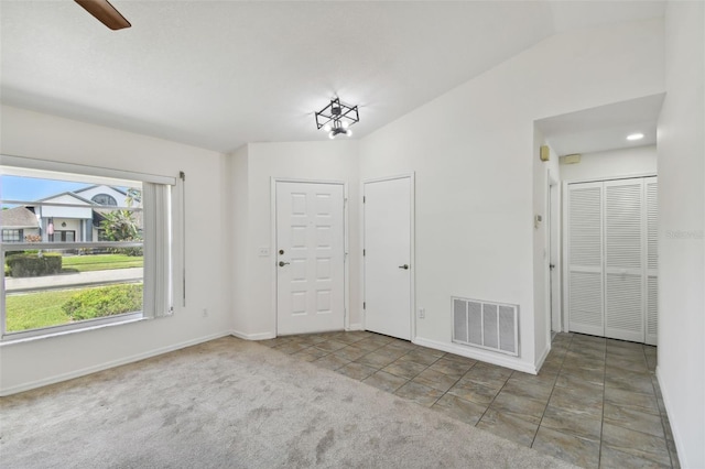 interior space with vaulted ceiling and ceiling fan