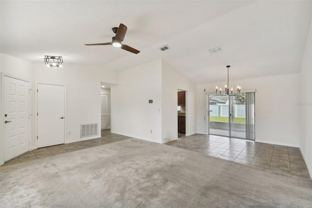 carpeted empty room with ceiling fan with notable chandelier and vaulted ceiling