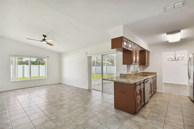 kitchen with lofted ceiling, light tile patterned floors, kitchen peninsula, stainless steel appliances, and ceiling fan with notable chandelier