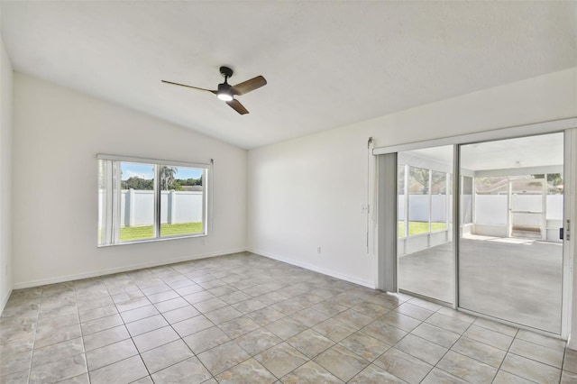 unfurnished room with vaulted ceiling, ceiling fan, and light tile patterned floors