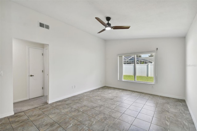 tiled spare room with vaulted ceiling and ceiling fan