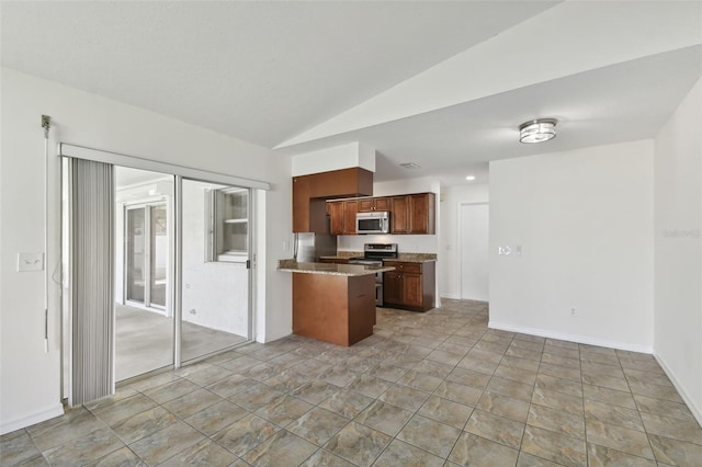 kitchen featuring appliances with stainless steel finishes, kitchen peninsula, and lofted ceiling