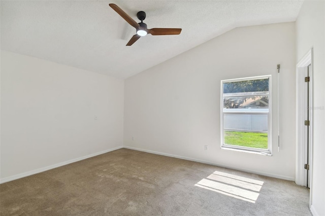 unfurnished room with vaulted ceiling, ceiling fan, light colored carpet, and a textured ceiling